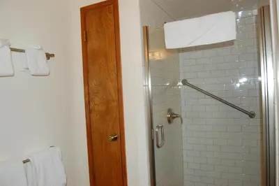 a bathroom with a shower with a glass door at 43A Mountain Retreat in Wawona