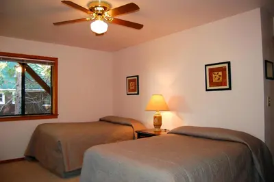 a bedroom with two beds and a ceiling fan at 5N Edmond's Place in Wawona