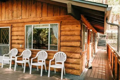 a group of chairs sitting on the porch of a cabin at 19B Yosemite Retreat in the Meadows in Wawona
