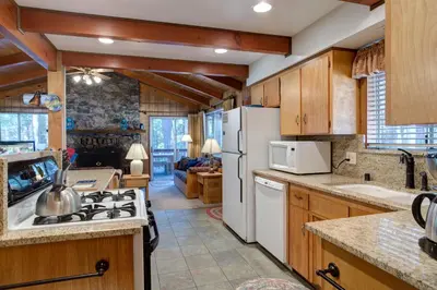 a kitchen with wooden cabinets and a white refrigerator at 23B Robins Nest in North Wawona