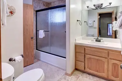 a bathroom with a shower and a toilet and a sink at 12 Cabin Twelve in Wawona