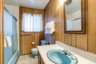 a bathroom with a sink and a toilet and a mirror at 9B Deer Hollow in Wawona