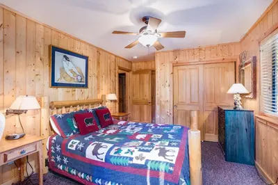 a bedroom with a bed and a ceiling fan at 21 River Refuge in North Wawona