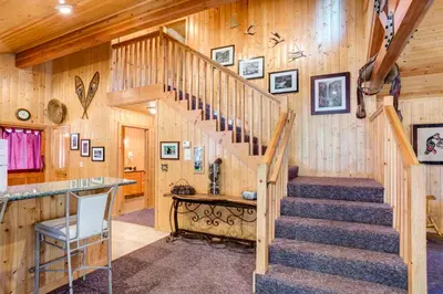 a staircase in a cabin with wooden walls at 21 River Refuge in North Wawona
