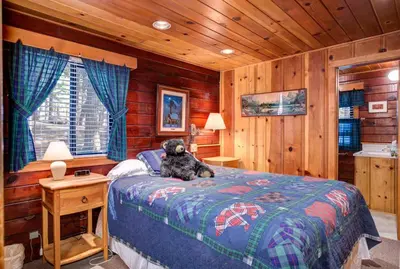 a teddy bear sitting on a bed in a bedroom at 51 Mia Mora in Wawona