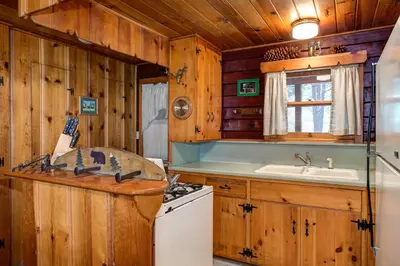 a kitchen with wooden cabinets and a sink and a stove at 51 Mia Mora in Wawona