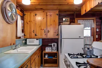 a kitchen with a stove and a white refrigerator at 51 Mia Mora in Wawona