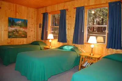 a bedroom with two green beds and a window at 11 Shangri la-de-da in Wawona