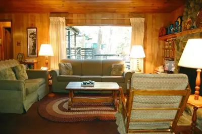 a living room with a couch and a table at 11 Shangri la-de-da in Wawona