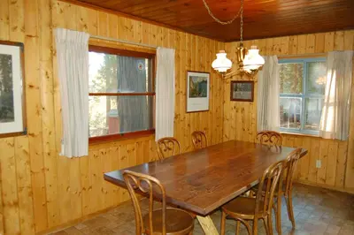 a dining room with a wooden table and chairs at 11 Shangri la-de-da in Wawona