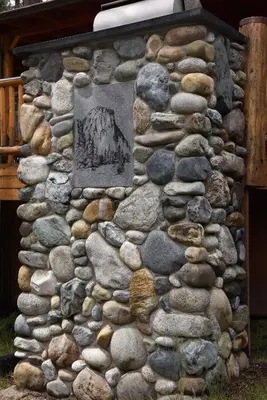 a stone wall with a monument on it at 72 Sequoia in North Wawona