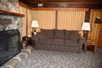 a living room with a couch and a fireplace at 72 Sequoia in North Wawona