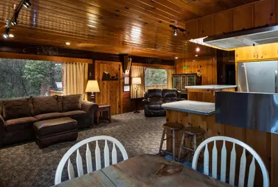 a living room with a couch and a table at 72 Sequoia in North Wawona