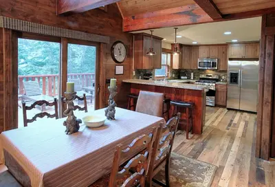 a kitchen with a table and a dining room at 9 Boot's Haven in North Wawona