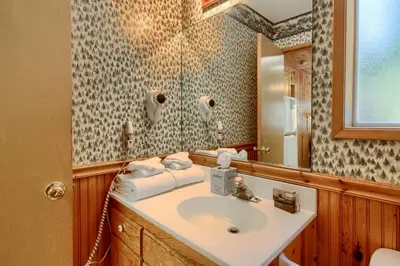 a bathroom with a sink and a mirror at 43R Edna's Hearts Desire in North Wawona