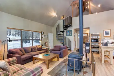 a living room with a couch and a stove at 7S Wawona Chalet in Wawona
