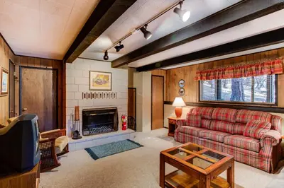 a living room with a couch and a fireplace at 18B Hiltbrand Hangout in Wawona