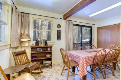 a dining room with a table and chairs at 80 Chattertons Cottage in North Wawona