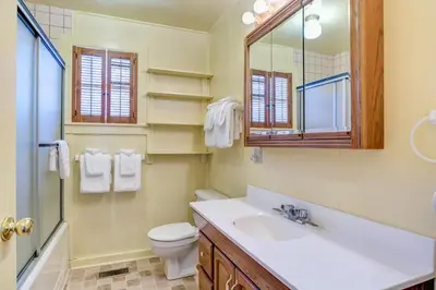a bathroom with a sink and a toilet and a mirror at 80 Chattertons Cottage in North Wawona