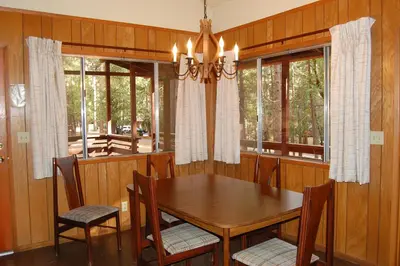 a dining room with a wooden table and chairs at 84 Hastings Hideaway in Wawona
