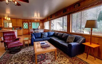 a living room with a blue couch and a table at 17A Longview in Wawona