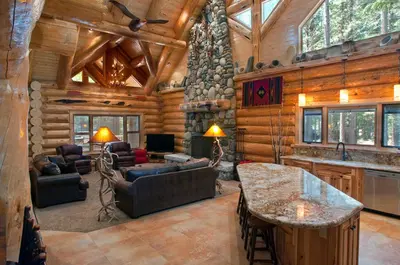 a living room in a log cabin with wooden walls at 67 El Capitan in North Wawona