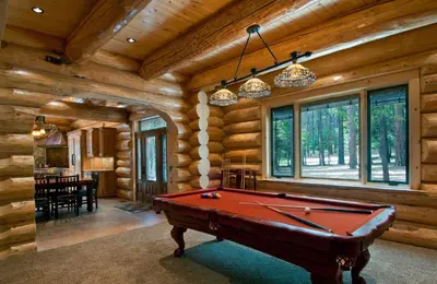 a pool table in a room with wooden walls at 67 El Capitan in North Wawona
