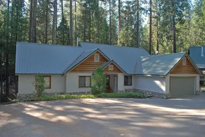 a house with a metal roof and a garage at 93 Doyles Mountain in Wawona