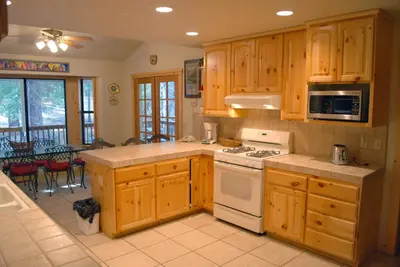 a kitchen with wooden cabinets and a stove top oven at 93 Doyles Mountain in Wawona