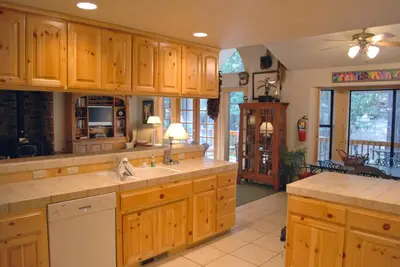 a large kitchen with wooden cabinets and a kitchen island at 93 Doyles Mountain in Wawona