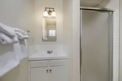 a white bathroom with a sink and a shower at 25A Villarreal Retreat in Wawona
