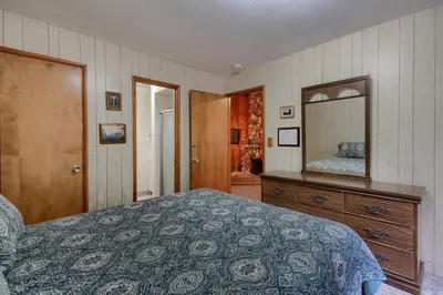 a bedroom with a bed and a dresser and a mirror at 25A Villarreal Retreat in Wawona