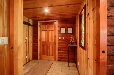a hallway in a log cabin with a door at 57 The Williams Cabin in Wawona