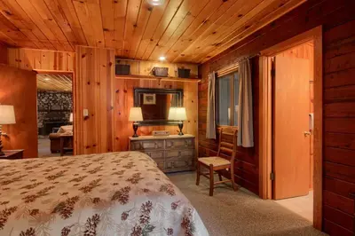 a bedroom with a bed and a desk at 57 The Williams Cabin in Wawona