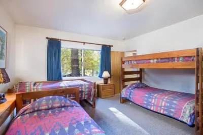 a bedroom with two bunk beds and a window at 15B The Legacy in Wawona