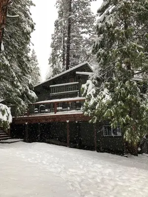 a house covered in snow in front at 15B The Legacy in Wawona
