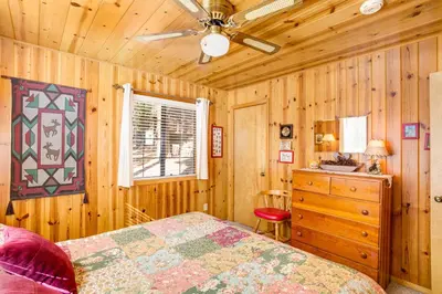 a bedroom with a bed and a ceiling fan at 7 Cedar Lodge in Wawona