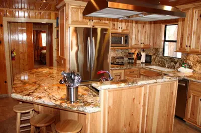 a kitchen with wooden cabinets and a stainless steel refrigerator at 66 Grizzly Giant in Wawona