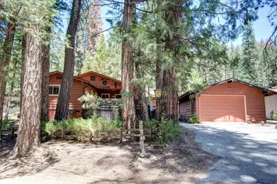 a house in the woods with a garage at 4B Mountain Memory in Wawona