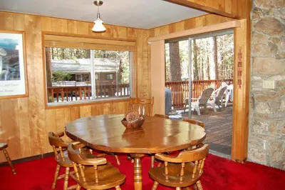 a dining room with a wooden table and chairs at 82 Shehadey's Retreat in North Wawona