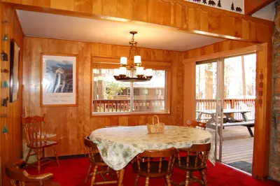a dining room with a table and chairs at 82 Shehadey's Retreat in North Wawona