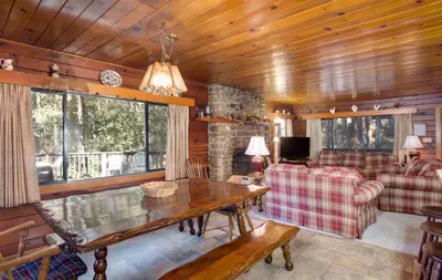 a living room with a table and a couch at 55 Deer Creek in Wawona