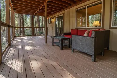 a screened porch with a couch and a table at 20B We-Dunn-It in Wawona