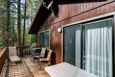a screened in porch with a table and chairs at 1S Cecils Cabin in South Wawona