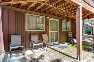 a screened porch with chairs and a house at 1S Cecils Cabin in South Wawona