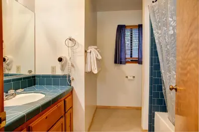a bathroom with a sink and a shower at 1S Cecils Cabin in South Wawona