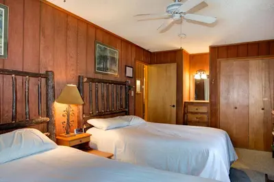 a bedroom with two beds and a ceiling fan at 12B Star Gazers in Wawona