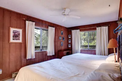 a bedroom with two beds and two windows at 12B Star Gazers in Wawona