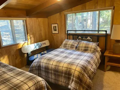 a bedroom with two beds and two windows at 3A Cutters Edge in Wawona