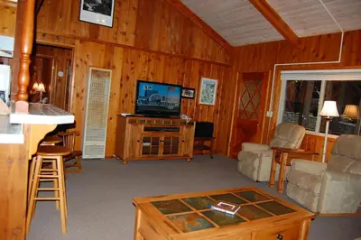 a living room with a tv and a table at 30A Dunnings Retreat in Wawona
